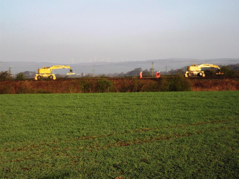 Photo of two track machines head down the main line towards Larbert