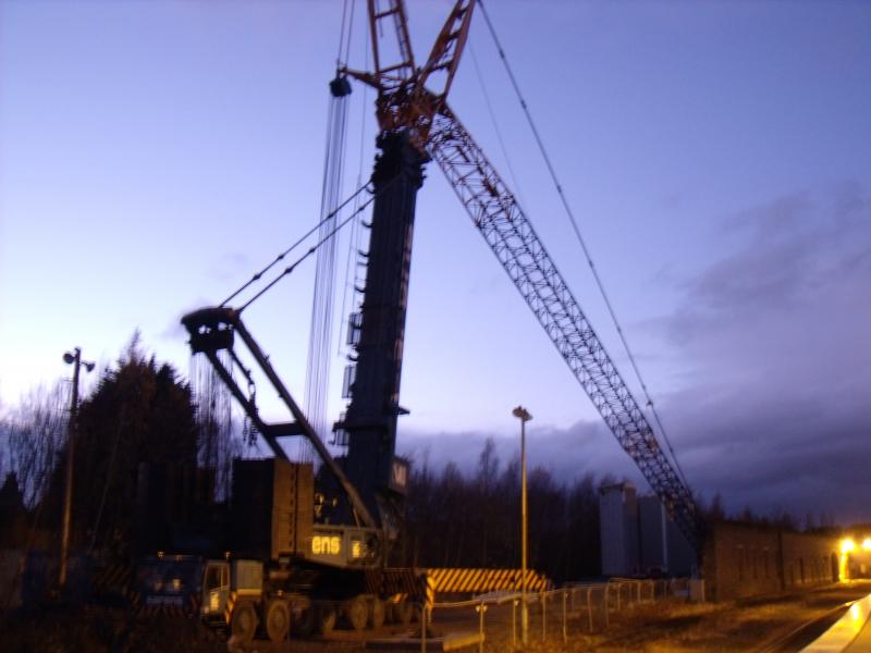 Photo of looked like the very long arm of the crane was being bolted together last thursday and there was hi-vis chaps working at the top of the towers in the background. 