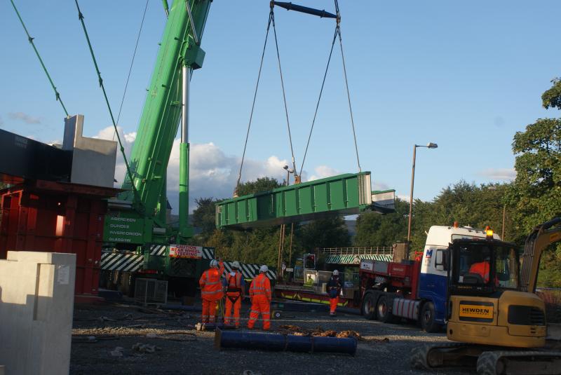 Photo of Causewayhead bridge's new southbound deck being lifted with the old bridge in the background