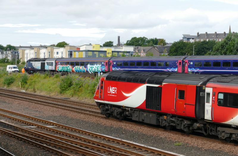 Photo of Power Car 43146 and 1st Class coach covered in graffiti in Dundee Yard. 