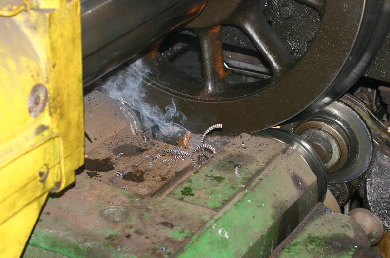 Making the cut: Smoke rises from the cutting head as it digs into the steel tyre as the wheel rotates. Photo of Making the cut
