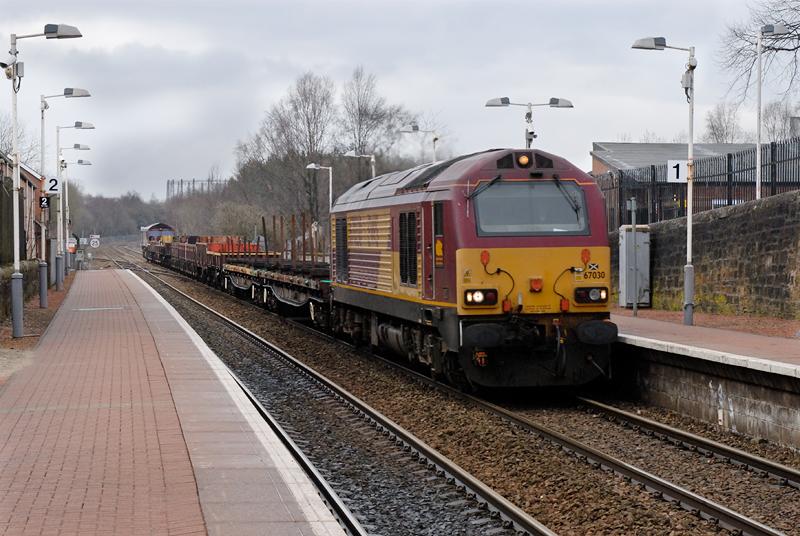 67030 on the 6K06: 67030 & 66113 T&T on the 6K06 Craigendoran to Mossend engineers train, photographed passing through Maryhill Station on time. 11:17 Sunday 13th March 2011. Thanks to Annoy A Mouse and 37001 for the times. Photo of 67030 on the 6K06